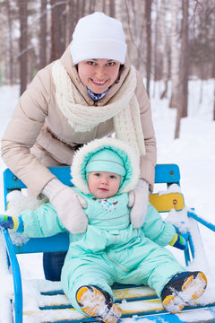 Happy Family Mother And Baby In Park In Winter