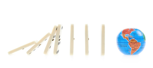 Domino pieces falling on to the globe
