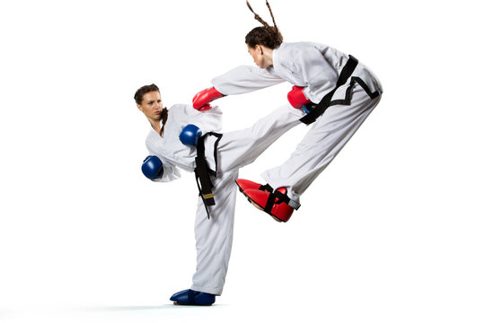 Two isolated professional female karate fighters are fighting