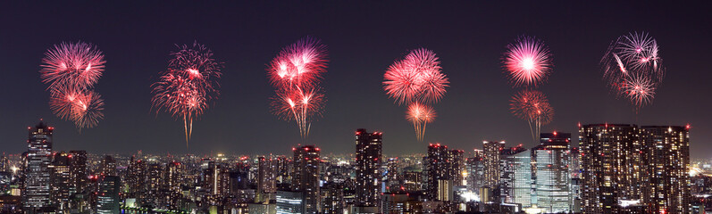 Fototapeta premium Fireworks celebrating over Tokyo cityscape at night