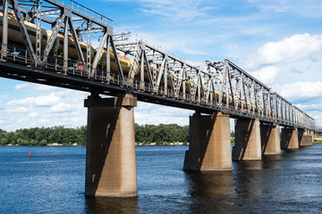 Railroad bridge in Kyiv across the Dnieper with freight train