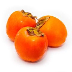 Persimon or sharon fruit isolated on a white studio background.