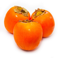 Persimon or sharon fruit isolated on a white studio background.