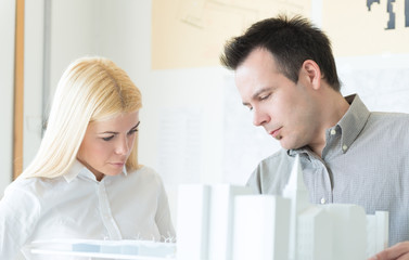 Fototapeta premium Young architects working on a new architectural models