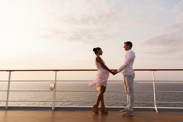 Fototapeta premium lovely couple holding hands on a cruise