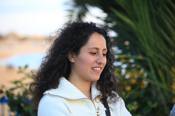 Smiling young sicilian girl near the beach at sunset