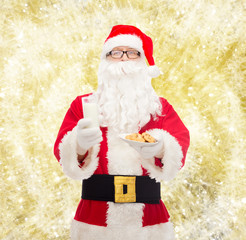 santa claus with glass of milk and cookies