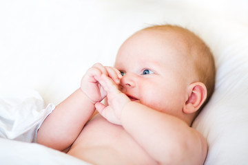 Peaceful newborn baby lying on a bed