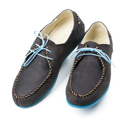 Black men's leather loafers with blue soles and laces on a white