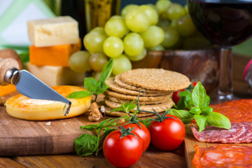 Table view on soft cheese with appetizers and red wine