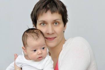 Happy mother holding her lovely newborn baby girl