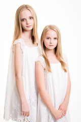 Two Beautiful Blond Teenage Girls Dressed in White.
