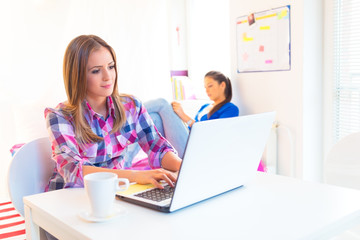 Young female student working on laptop