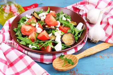 Eggplant salad with tomatoes, arugula and feta cheese,