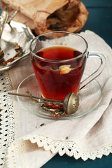 Beautiful vintage composition with herbal tea, on wooden table