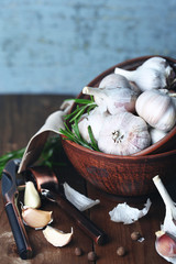 Raw garlic and spices on wooden table