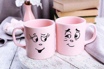 Emotional cups on wooden table