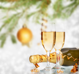 Glasses with champagne and bottle over holiday background