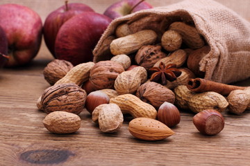 Nuts in jute sack cinnamon sticks, star anise