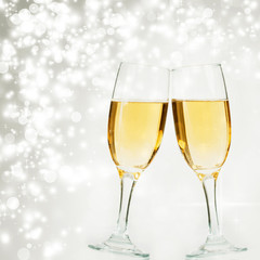 Champagne glasses against holiday lights