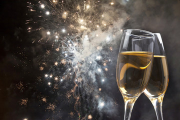 Glasses with champagne against fireworks © erika8213
