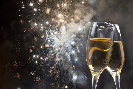 Glasses with champagne against fireworks