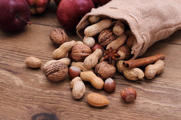 Nuts in jute sack cinnamon sticks, star anise