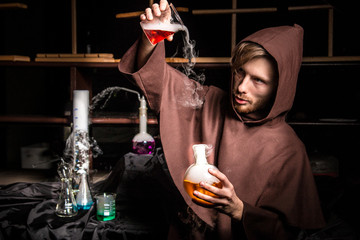 Alchemist in chemical laboratory prepares magical liquids