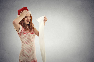 Christmas woman red Santa hat holding long wish list stressed