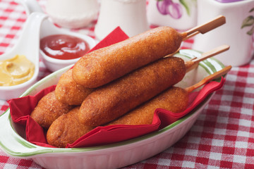 Corn dog with ketchup and mustard