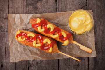 Corn dog with ketchup and mustard