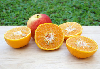 Fototapeta premium apples, oranges and lemons on white wooden table background
