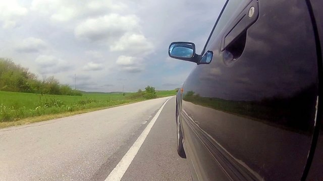 Driving black car on an urban road 