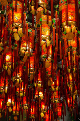 Closeup of many lit red lamps/lanterns in a temple
