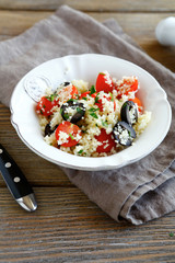 couscous salad with tomatoes and olives on a plate