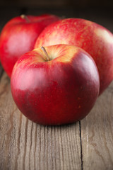 Red apples on wood