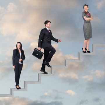 Three business people walking on the ladder
