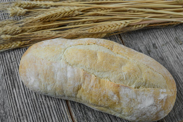 Bread and Wheat on Rustic Wood Background