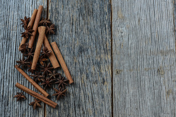 Cinnamon sticks and star anise on rustic wood background