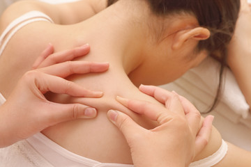 Fototapeta na wymiar closeup asian woman having deep massage on her back in spa