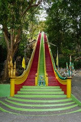 Naklejka premium green and red walking way to the Thai Buddhist temple