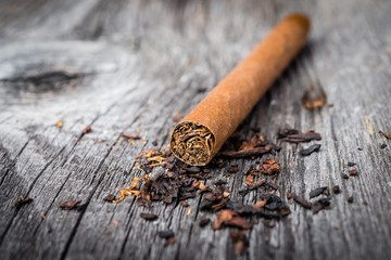 brown cigar on grey wooden table. Selective focus.