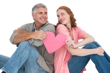 Casual couple holding pink heart