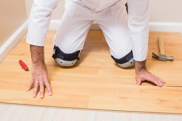 Fototapeta premium Carpenter putting down new wooden planks