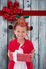 Composite image of cute little girl wearing rudolph headband