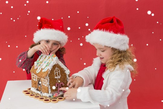 Festive Little Girls Making A Gingerbread House