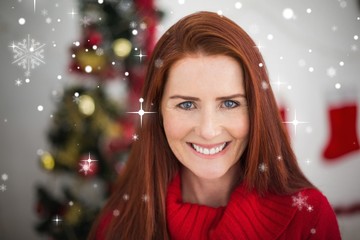 Composite image of festive redhead smiling at camera