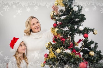 Mother and daughter decorating christmas tree