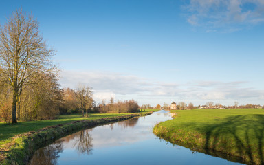 Fototapeta na wymiar Small meandering river in a Dutch polder landscape