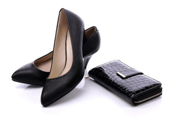 Women's shoes and a black wallet on a white background - obrazy, fototapety, plakaty